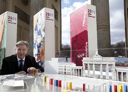 Klaus Wowereit, alcalde de Berlín, con la maqueta del 'efecto dominó' junto a la Puerta de Brandemburgo.